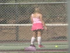 Tennis coach shows his student the wet racket game